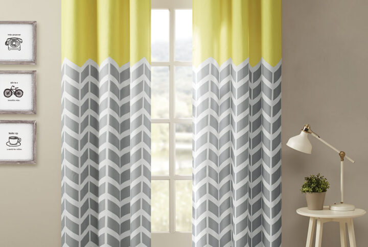 Our Intelligent Design Alex Chevron Printed Room Darkening Panel Pair adds bright color and fun style to your room. These window panels feature a contrast color chevron print with solid top border