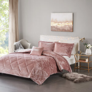 Create a lush and relaxing atmosphere in your bedroom with the Intelligent Design Felicia Velvet Comforter Set. The blush comforter is made from crushed velvet and features diamond quilting for a luxurious look. Matching crushed velvet sham(s) and an oblong decorative pillow complement the comforter to complete the modern style bedding set. Machine washable for easy care