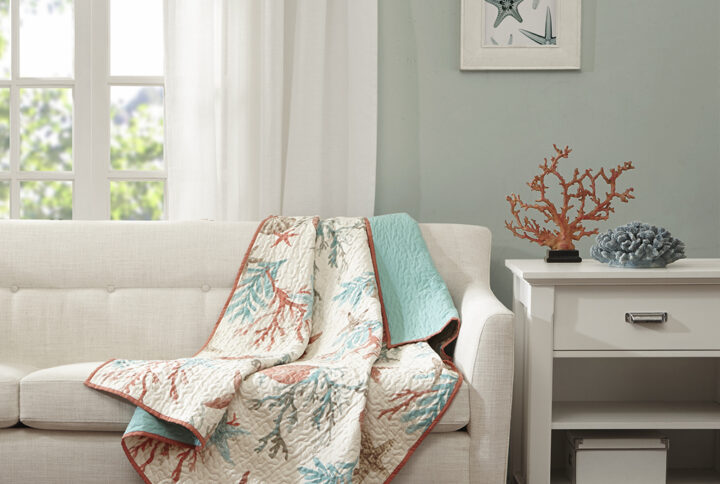 This Madison Park quilted throw creates a casual coastal look. The throw features starfish and coral motifs accentuated with coral and aqua colors and reverses to an aqua blue. It's oversized and overfilled for added comfort and style.