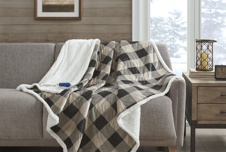 Stay warm and indulge in pure comfort with the Woolrich Linden Heated Throw. This tan heated throw features a soft mink face with a solid and cozy berber reverse that creates a luxurious look with an incredibly soft feel. The attached controller provides 3 different temperature settings to provide the perfect level of warmth that keeps you the most comfortable when bundled up. The controller also has a 2 hour auto shut off timer to ensure your safety during prolonged use. Machine washable for easy care