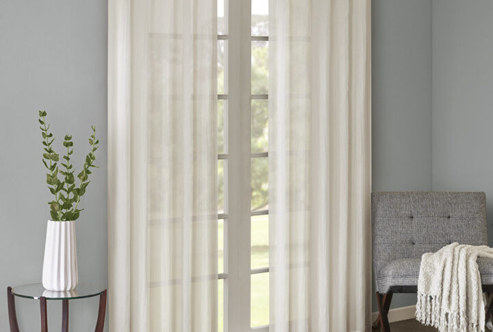 Add a fresh contemporary style to your home with Madison Park’s Harper Solid Crushed Window Panel Pair. Made from a lightweight white sheer fabric