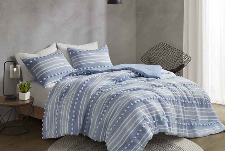 The Urban Habitat Rowan duvet cover set features cationic dyed stripes and clip jacquard pompom details that bring a perfect blend of modern and casual style to your bedroom. The duvet cover has a soft microfiber reverse