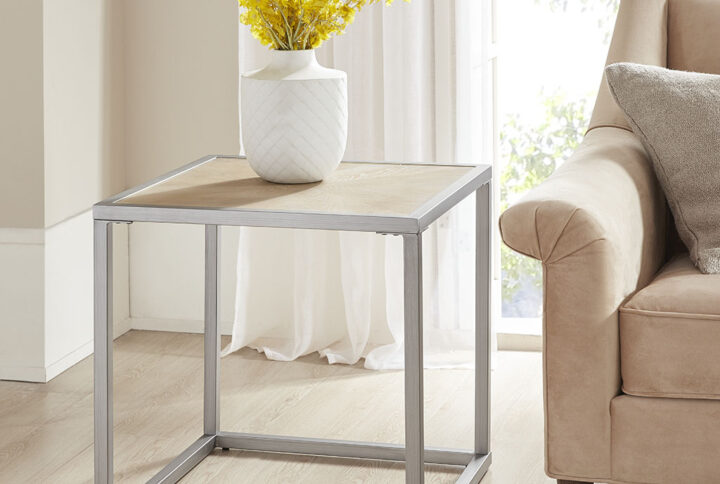 Complete your living space with the simple and clean allure of the Madison Park Willow End Table. This square table features a solid veneer top with a natural wood finish to give it a warm and welcoming look. The antique brushed silver metal base complements the table top to complete the transitional design. Elevate your home decor by incorporating this end table into your living room.  Assembly is required and tools are included.