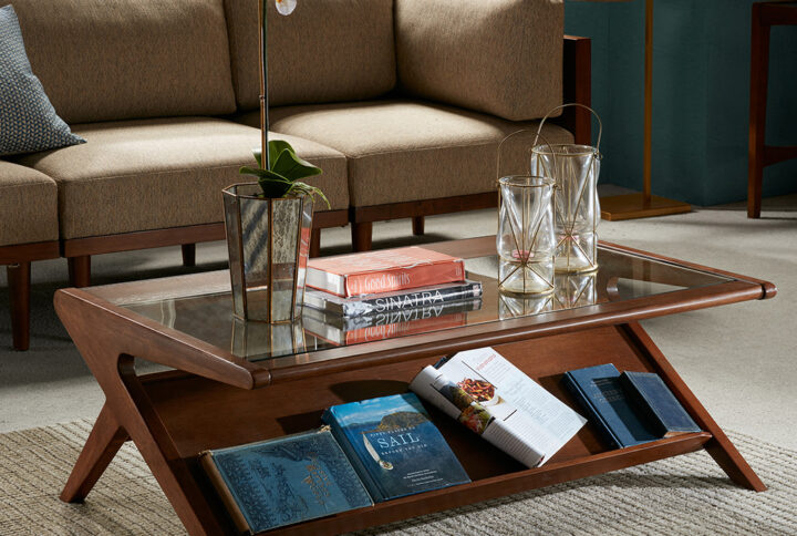 Create a unique living room display with the INK+IVY Rocket Coffee Table with Tempered Glass. This rectangular coffee table features a unique angular design in a pecan finish with a tempered glass table top