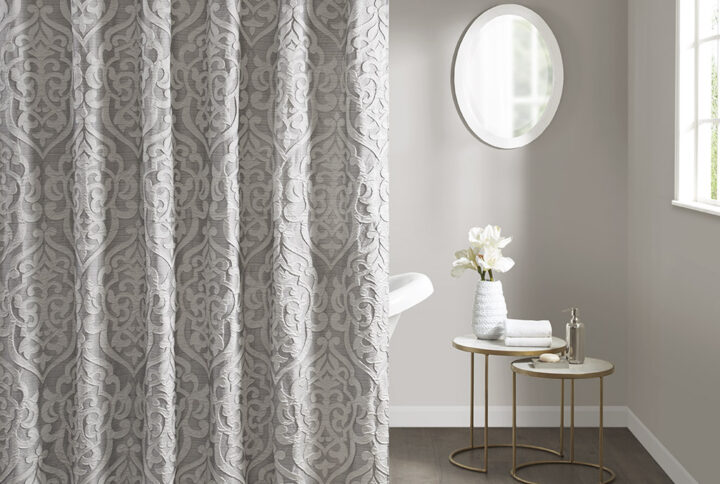 Add a touch of class to your bathroom with our Madison Park Odette Jacquard Shower Curtain. This luxurious textured shower curtain flaunts a gorgeous silver damask medallion design on a stria grey jacquard ground that adds rich texture and dimension to the lavish look. Measuring 72x72"