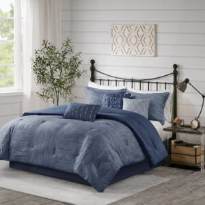 The Madison Park Walter 7 Piece Printed Seersucker Comforter Set offers a chic modern update to your bedroom. This navy comforter set features a pieced