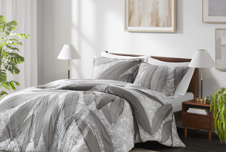 Bring a touch of nature and elegance to your bedroom with this stunning botanical duvet cover set. The duvet cover features a large scale botanical design in shades of gray that contrasts beautifully with a smaller scale botanical print in white