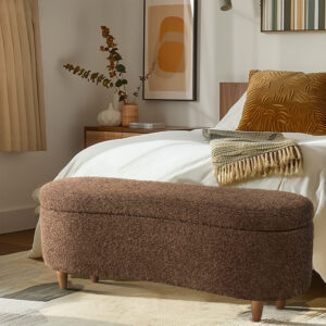 it also has a straight back that fits snugly against a wall or bed. The upholstered bench sits atop solid wood legs