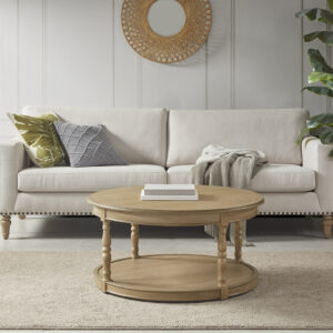 The Martha Stewart Belden Caster Coffee Table offers a charming farmhouse update to your living room. The round coffee table features a natural wood finish with solid wood turned legs that add an elegant touch to the country-inspired look. A lower shelf provides plenty of space to store or display your magazines and other essentials. Below the base and solid wood legs