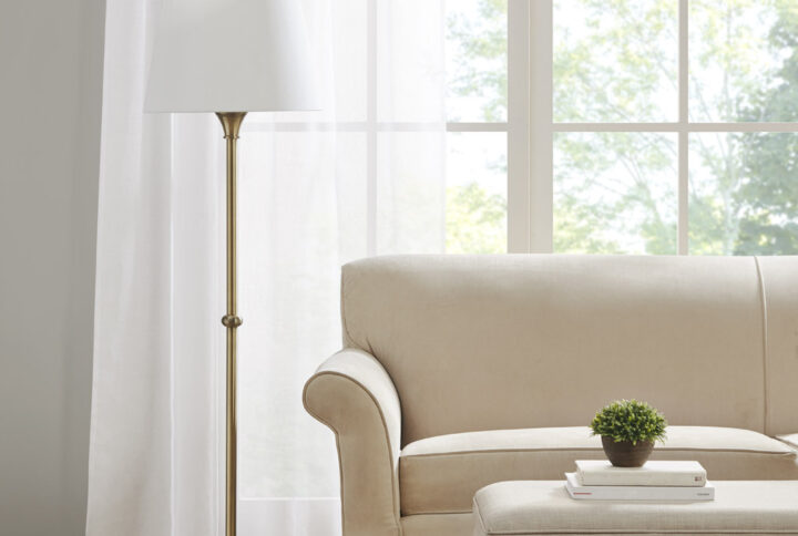 Add a touch of elegance to your living space with this beautiful Aelorian floor lamp from the Bedford collection by Martha Stewart. This classic lamp features an antique brass finish and an empire fabric shade in off-white color. The on/off rotary switch is on socket and the lamp plugs in