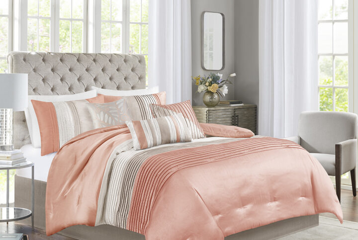 Amherst's modern color blocked design is a simple way to add style to your room. This comforter is covered in larges stripes in shades of coral and taupe. Made from polyester jacquard and a brushed fabric reverse this comforter is soft to the touch and is machine washable for easy care. The comforter set includes two matching standard shams and three decorative pillows that accent the color blocked look.