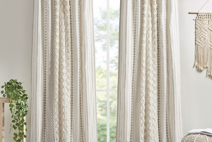 The INK+IVY Imani Cotton Printed Window Panel with Chenille Stripe and Lining offers a chic and casual update to your home. This ivory window panel features a geometric print with a tufted chenille stripe trim