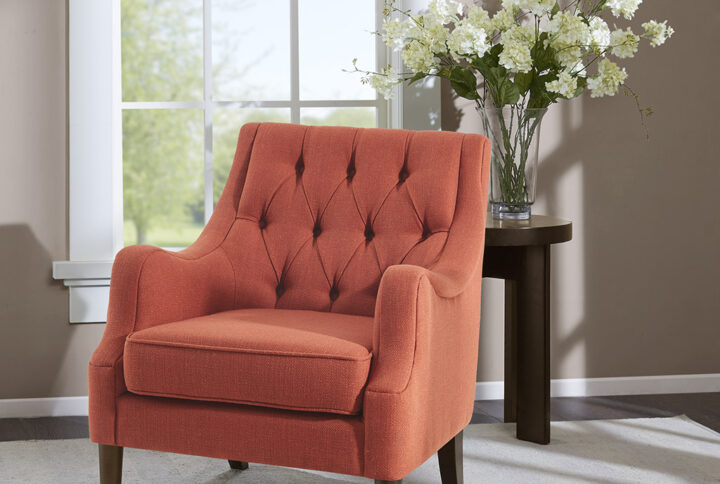 Grace your living room with the Madison Park Qwen Button Tufted Chair. This vintage inspired frame features sweeping serpentine arms and deep button tufting to create a soft diamond accent. The tight back chair is upholstered in a vibrant spice fabric. It is elevated on elegantly tapered solid wood legs in espresso finish. Leg assembly required.