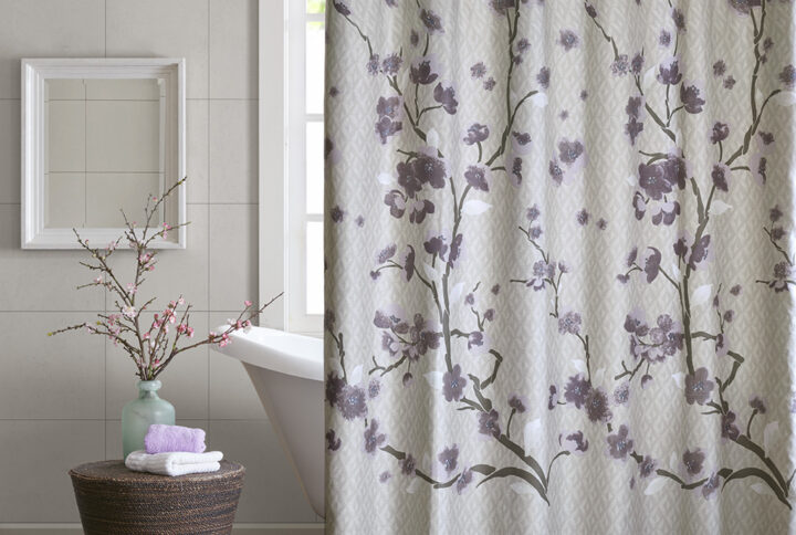 Put a modern touch on your decor with the Madison Park Holly Collection. This 100% cotton shower curtain features an allover cherry blossom design with branches. The soft grey background pairs beautifully with the purple and grey flowers for the perfect update to your space. Machine washable for easy care