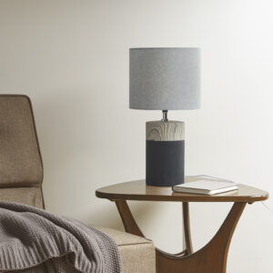 Elevate your decor and illuminate your home with the contemporary style of the 510 Design Nicolo Textured Ceramic Table Lamp. This round table lamp features a two-tone ceramic base in white with a brown wood grain pattern to create a stunning modern look. The drum lamp shade softly filters the light to provide a warm ambiance in your space. Flaunting a simple