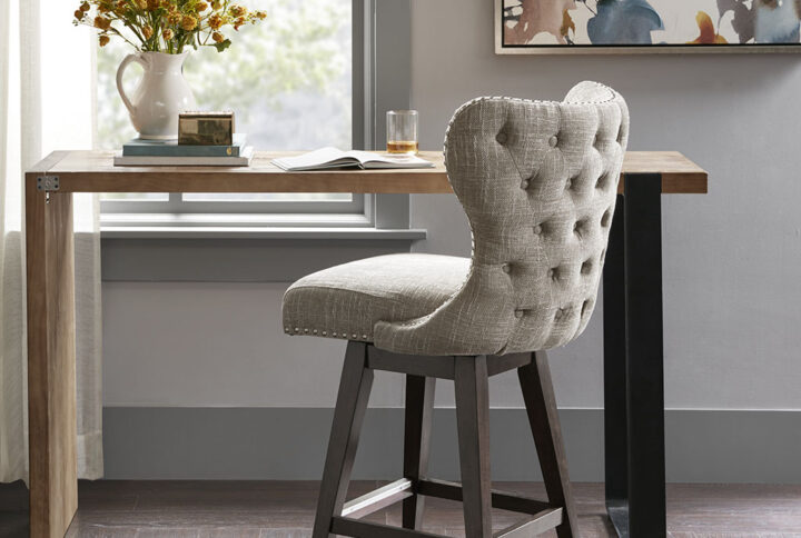 The Madison Park Hancock Swivel Counter Stool complements any decor with its simple