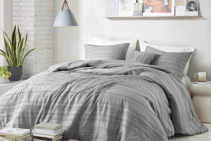 Add a casual and modern touch to your bedroom with the Oliver clip jacquard comforter set. The comforter and matching shams (1 in Twin/Twin XL) feature a woven striped pattern and clip jacquard design for a contemporary update to your bedroom