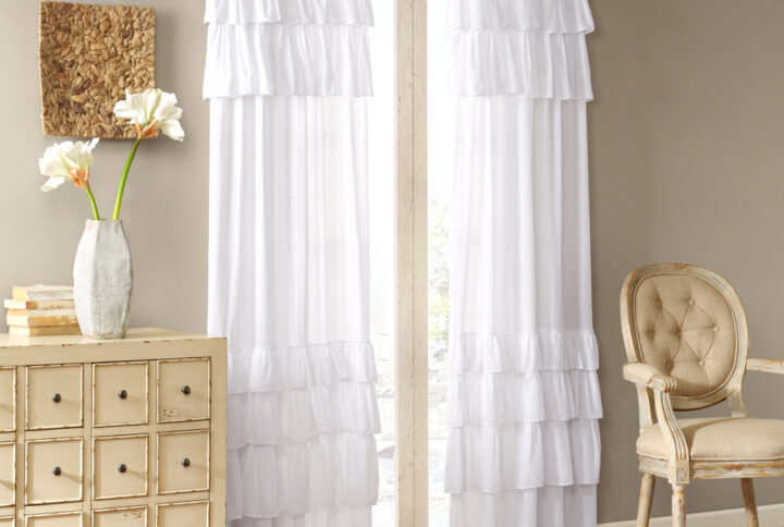 Vintage chic meets southern charm with the Madison Park Anna Window Curtain. This window panel features oversized ruffles in a crisp white that adds charm and sophistication to your home décor. Made from 100% cotton voile