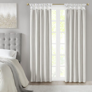 Energy efficiency meets a sophisticated style with the Madison Park Emilia Twist Tab Total Blackout Window Curtain. This window curtain panel showcases a DIY twist tab top finish that allows you to create an elegant display in your living room or bedroom space. The faux silk sheen base fabric features a 3 pass foamback liner on the reverse to block out all outside light