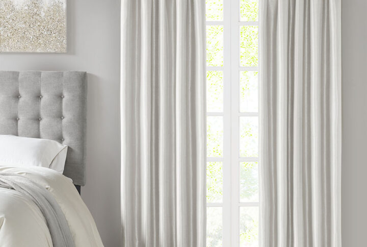 Energy efficiency meets a sophisticated style with the Madison Park Emilia Twist Tab Total Blackout Window Curtain. This window curtain panel showcases a DIY twist tab top finish that allows you to create an elegant display in your living room or bedroom space. The faux silk sheen base fabric features a 3 pass foamback liner on the reverse to block out all outside light