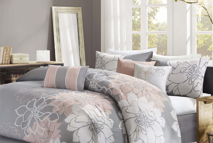 The Madison Park Lola Comforter Set transforms your bedroom into a beautiful and graceful space. A gorgeous floral print in a soft white and peach hue pops against the solid grey ground cotton sateen comforter and shams (1 for Twin/Twin XL Sizes) for a stunning transitional look. Three decorative pillows with embroidered details and fabric manipulation add texture and dimension to the bed