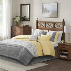 Elegantly update your bedroom with the Madison Park Serene 7 Piece Comforter Set. A beautifully embroidered floral pattern is showcased on the faux silk comforter. The pieced design