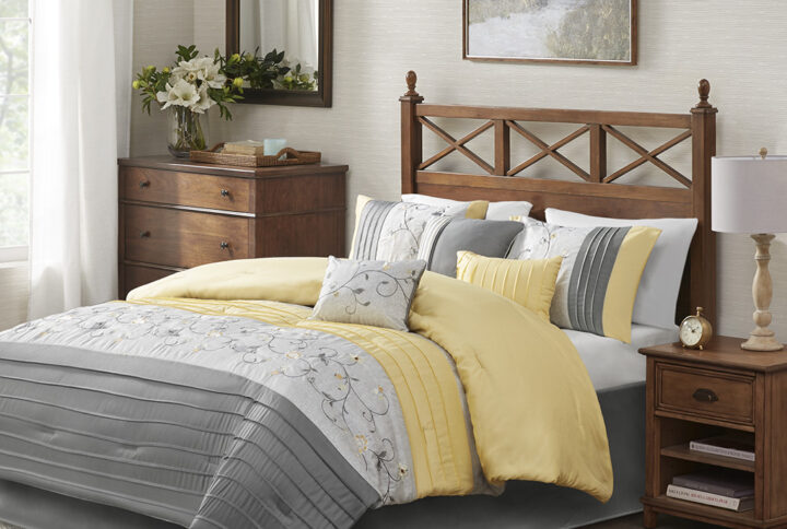 Elegantly update your bedroom with the Madison Park Serene 7 Piece Comforter Set. A beautifully embroidered floral pattern is showcased on the faux silk comforter. The pieced design