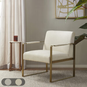 Elevate your living room decor with the luxurious style of the Martha Stewart Jayco Accent Chair from Perry Street collection. The seat and back are upholstered in a rich plush fabric that is complemented by the antique gold metal arms and legs