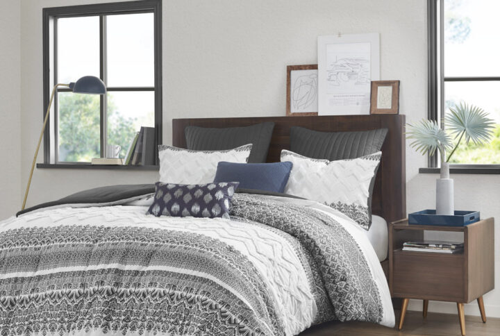 Transform your bedroom with the charming shabby chic allure of the INK+IVY Mila 3 Piece Cotton Comforter Set with Chenille Tufting. The cotton comforter flaunts an updated gray botanic print