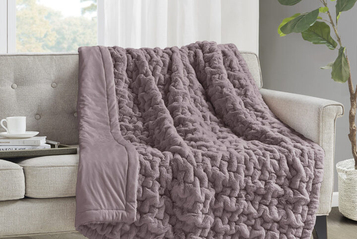 Add a modern and sophisticated touch to any space with the Madison Park Ruched Fur Throw. This throw features a solid ruched fur pattern