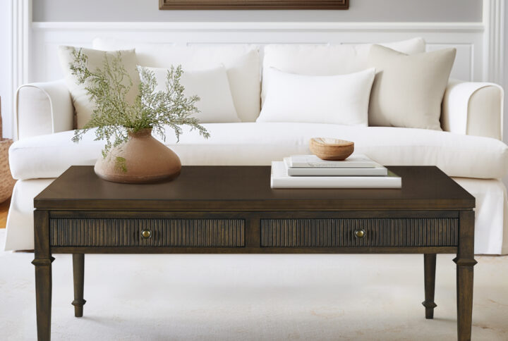 Enhance your living space with the timeless elegance of Martha Stewart's Lily Pond collection. The dark brown wood veneer coffee table combines classic design with practicality. Two drawers on one side offer convenient storage