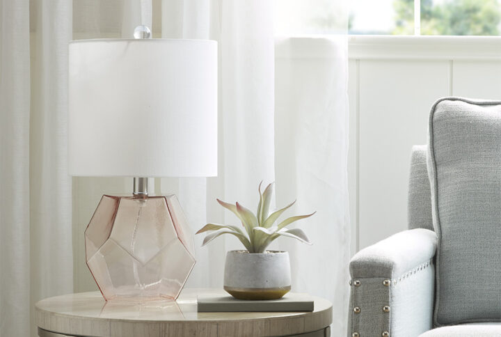 Elevate your home decor with the unique style of the 510 Design Bella Geometric Glass Table Lamp. This table lamp features a pink glass base with a white drum shade that creates a beautiful and eye-catching contrast. A 60-inch clear cord provides plenty of length to fit this glass table lamp in any room of your home. With simple and clean design