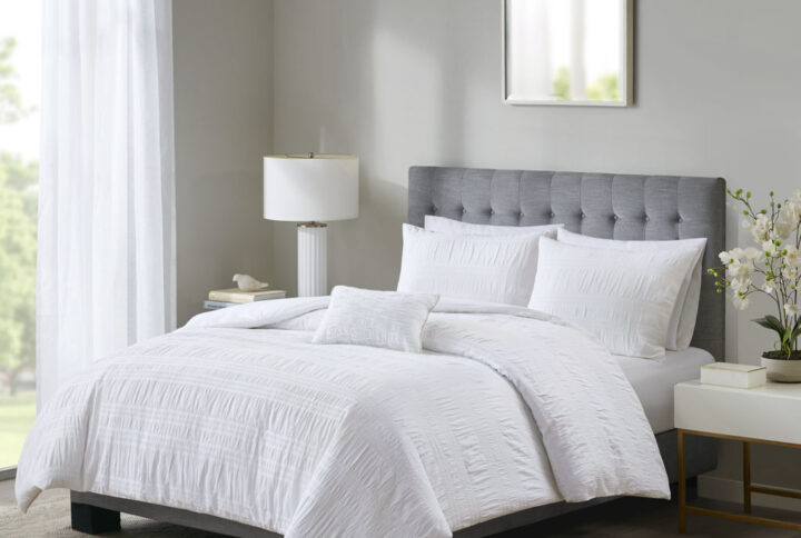 The Madison Park Nicolette 4 Piece Duvet Cover Set turns your bedroom into a cozy getaway. This seersucker duvet cover showcases a simple