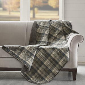 The Woolrich Tasha quilted throw features an all over brown and tan plaid and reverses to a solid brown color. Made from 100% cotton this lightweight throw is soft to the touch and can be used year round.