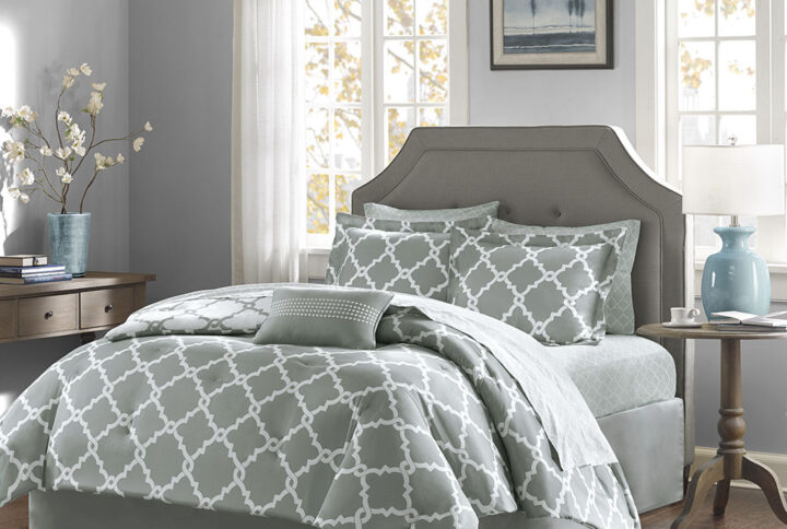 The Madison Park Essentials Merritt Reversible Complete Comforter and Cotton Sheet Set adds a simple yet chic look to your space. The comforter features a fretwork design against a vivid base that flips the color scheme on the reverse