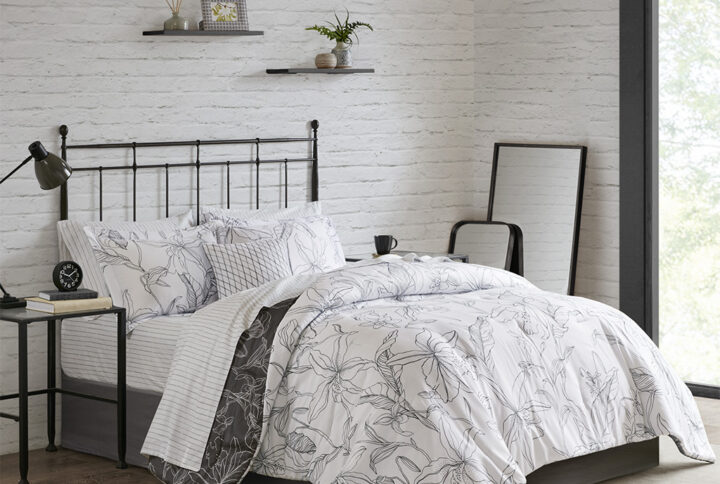 The Madison Park Essentials Lilia Reversible Complete Bedding Set with Cotton Sheet Set offers a modern update to your bedroom. The reversible comforter and shams (1 in Twin sizes) feature a botanic print in charcoal grey on a white base that flips the color scheme on the reverse. A solid grey bedskirt and a square decorative pillow with embroidered details add the perfect finishing touches. Also included is a striped 100% cotton sheet set that coordinates with the comforter set. Bringing the best in health and wellness