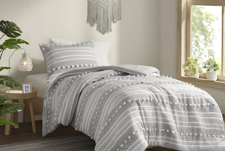 The Urban Habitat Rowan comforter set features cationic dyed stripes and clip jacquard pompom details that bring a perfect blend of modern and casual style to your bedroom. The comforter has a soft microfiber reverse