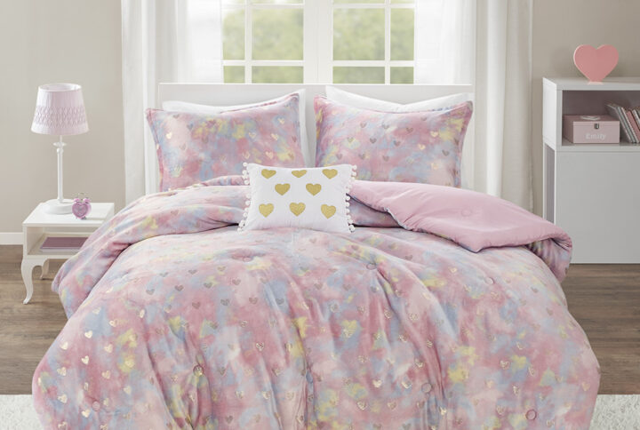 The Mi Zone Rosalie Metallic Printed Plush Comforter Set brings a bright and casual update to your bedroom. A gold metallic heart print adorns the tie-dye plush comforter and shams (1 in Twin/TwinXL) creating a soft and fun look. An oblong decorative pillow with a pompom trim and embroidered hearts adds a lovely touch to the bedding set. The hypoallergenic polyester comforter filling contains no allergens and is treated to be dustproof