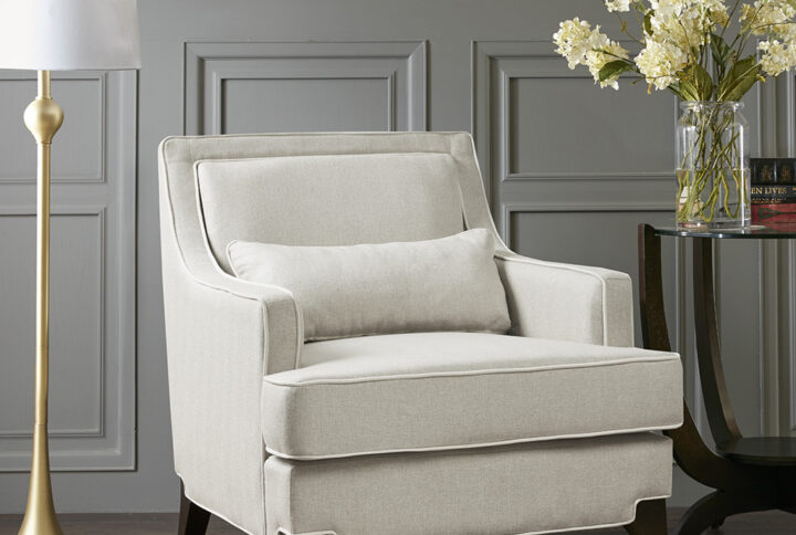 Refined and relaxed all in one chair. Cream upholstery is combined with contrasting ivory welting