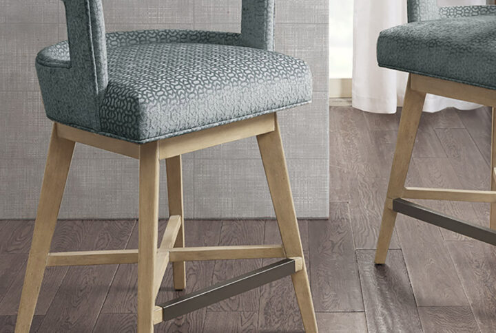 Update your kitchen dining decor with the Madison Park Glenwood Swivel Counter Stool. This counter stool features a low open back and is upholstered for a charming contemporary look. The solid wood legs complement the upholstery with the wheat color finish