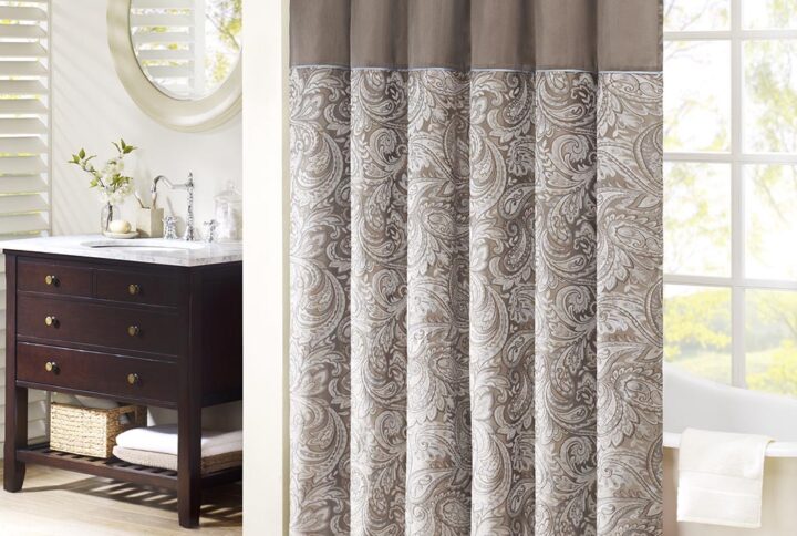 The Madison Park Aubrey Polyester Jacquard Shower Curtain creates a sophisticated modern look in your bathroom. The pieced design flaunts a beautiful woven jacquard in an updated paisley motif with a large solid stripe at the top of the shower curtain. This jacquard shower curtain is machine washable for easy care. Complete the collection and look with coordinate bath towels