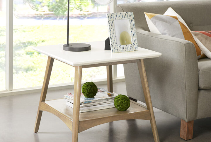 Add the bold Madison Park Parker End Table to your living space. This all wooden mid-century inspired desk will go nicely with your living room decor. It features a Off-white finish table top composed from manufactured wood