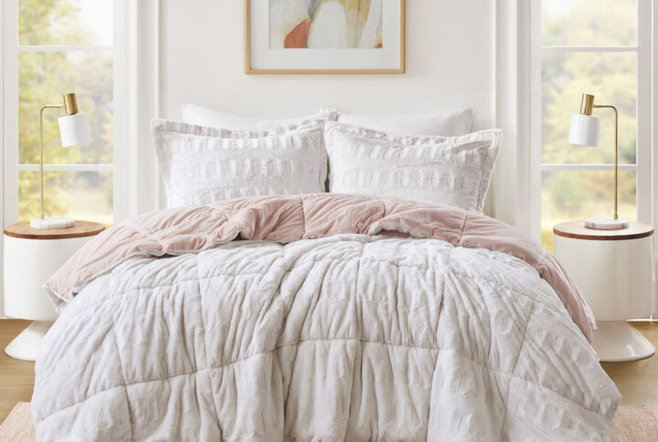 Sleep in the pure softness and comfort of the Madison Park Gia Back Print Long Fur Comforter Mini Set. The ultra-soft blush comforter flaunts a stylish brushed faux fur on the face that flips to a soft faux mink reverse