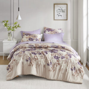 taupe and white watercolor floral print across the center of the neutral bedding