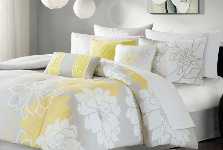 The Madison Park Lola Comforter Set transforms your bedroom into a beautiful and graceful space. A gorgeous floral print in a soft white and yellow hue pops against the solid taupe grey ground cotton sateen comforter and shams (1 for Twin/Twin XL Sizes) for a stunning transitional look. Three decorative pillows with embroidered details and fabric manipulation add texture and dimension to the bed