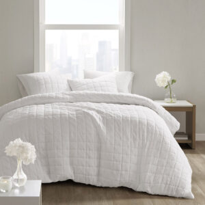 The simple elegance of the Cocoon 3 Piece Quilt Top Comforter Mini Set by N Natori brings an elevated update to your bedroom. The oversized and overfilled comforter flaunts super soft crushed microfiber with a lofty over-quilted box pattern