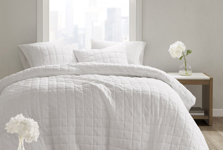 The simple elegance of the Cocoon 3 Piece Quilt Top Comforter Mini Set by N Natori brings an elevated update to your bedroom. The oversized and overfilled comforter flaunts super soft crushed microfiber with a lofty over-quilted box pattern