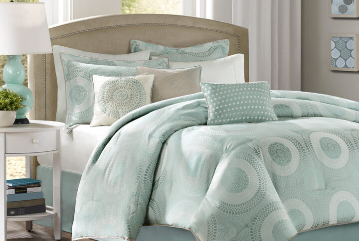 Create a calm and peaceful atmosphere in your room with the Madison Park Baxter 7 piece comforter set. This comforter has a light sage color on both sides and is made of a polyester jacquard fabric with a stunning geometric pattern in seafoam blues and greens. A flange of 1/2" in a slight dark taupe adds contrast and harmony to the blue and green hues. Three decorative pillows with embroidery and pleating details complete this tranquil look. Machine washable for easy care.