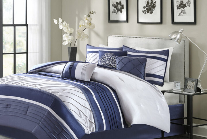 The Madison Park Blaire 7 Piece Comforter Set offers a rich traditional update to your bedroom decor. The comforter and matching shams feature pieced lustrous silk fabric and pintucking details