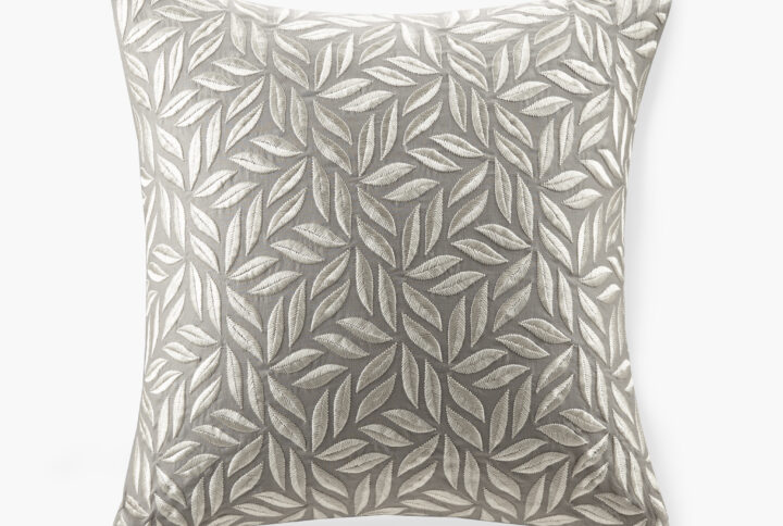 This Melodia pillow features continuous leaf all-over embroidery on natural cotton-linen. It's a chic and glamorous look that can pair well with both elegant and luxury bedding sets. It comes with a soft and plump removable white goose feather insert.